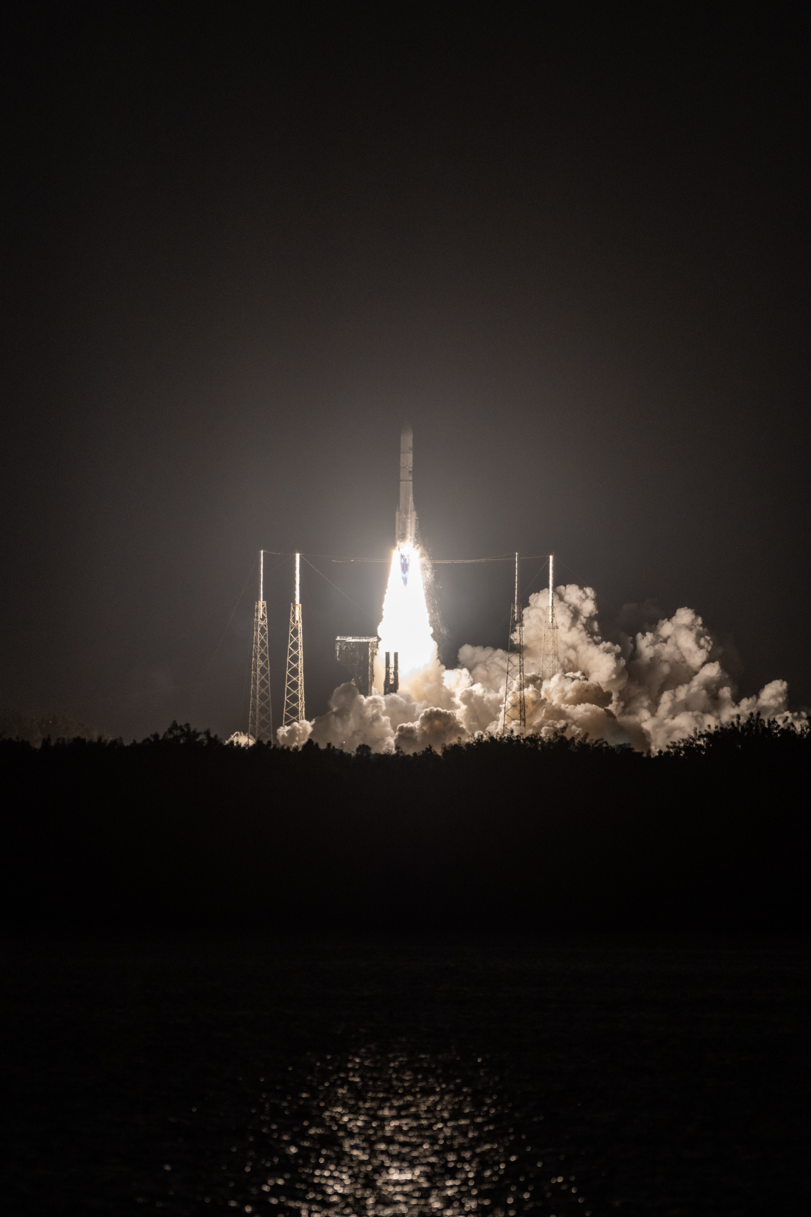 Telephoto shot of Vulcan clearing the tower at SLC-41 with the plume behind it illuminated by the bright exhaust.